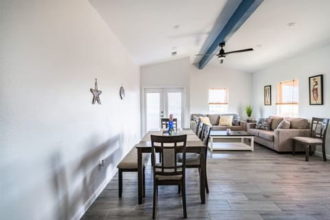 Open living and dining area with vaulted ceilings
