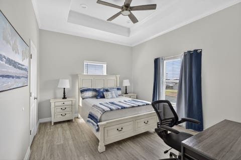 Bedroom with its own bath, a desk and a TV