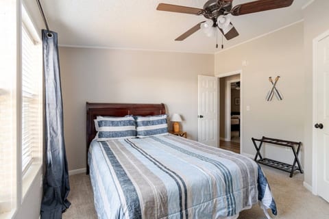 Queen bedroom with soft striped bedding