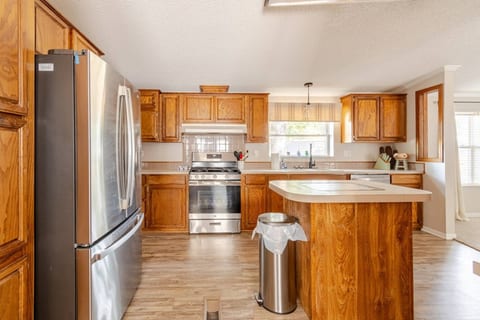 Kitchen with a gas range, island and stainless appliances