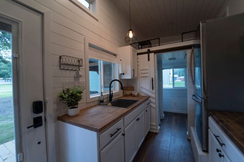 Kitchenette with butcher-block counters and a full-size fridge