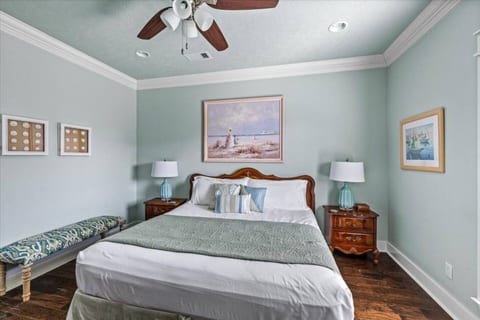 Bedroom with a large bed and coastal art
