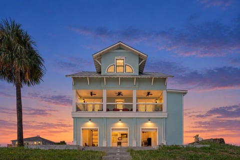 Twilight glow on this three-story waterfront home