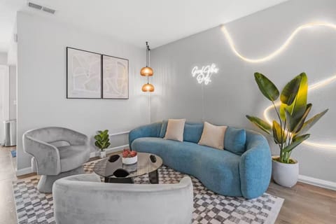 Stylish living room with a curved velvet sofa and neon accents