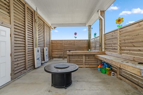 Outdoor bar and fire table in the shade under the house