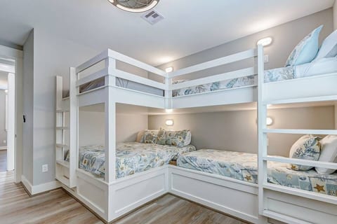 Built-in bunk room with reading lights at every bed