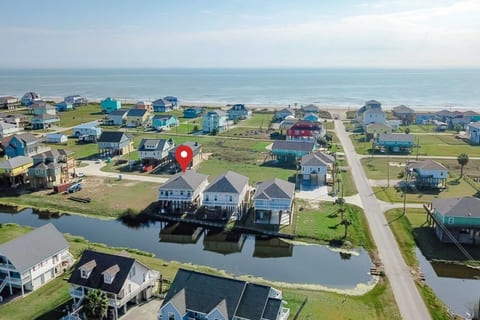 Aerial view: the house sits on a canal, a short walk from the beach