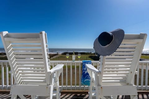 Tall deck chairs with a front-row view of the beach