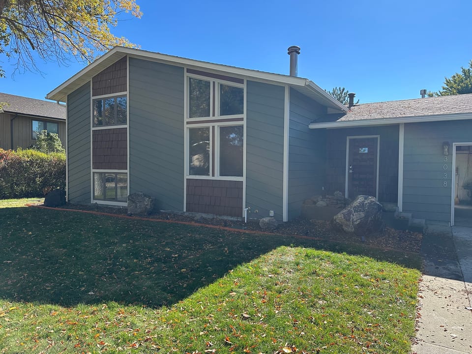 Inviting home exterior with large windows and tidy front lawn