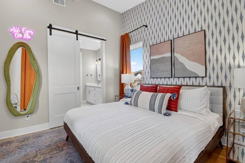 King Suite | 2nd Floor | En-Suite Bathroom
Stylish king bedroom with a bold patterned accent wall, chic décor, and “All Eyes On Me” neon sign for a fun, Insta-ready stay.