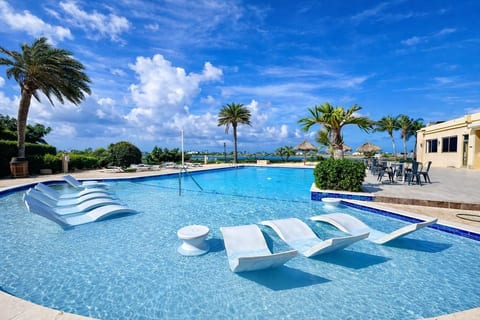 Main shared Gold Coast pool with in-water loungers.