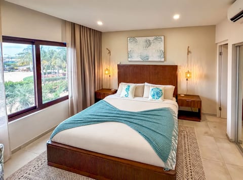 Separate bedroom with a king bed, air conditioning and room-darkening shades.