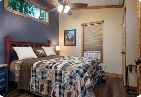 Cozy rustic bedroom with treetop views, AC, and cabin-style charm