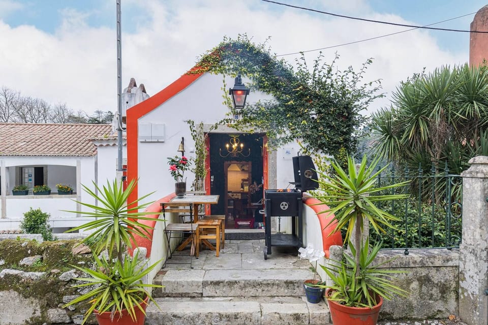 Entrance to the Smart Chapel, with your private outdoor seating area, a table for four and a barbecue. Steps lead up from the street.