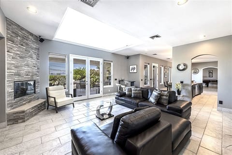 Large skylight in living room, doors out to covered patio