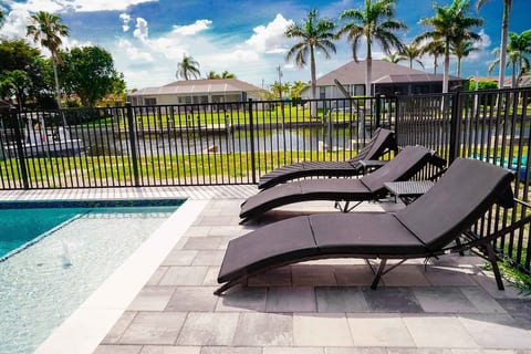Private heated pool deck with comfortable loungers and tranquil canal views. Fully fenced for peace of mind while soaking up the Florida sunshine.