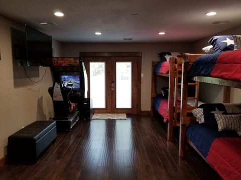 Fun Bunk Room with twin XL mattresses to fit even BIG KIDS and a large 65'' screen TV and a Real Driving Game for kids big and small. The small trunk under the tv has an Xbox 360 with rock band instruments and a Nintendo Wii as well.