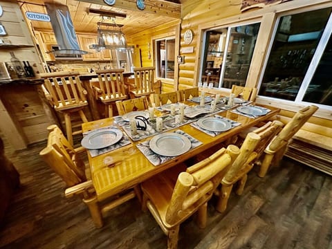 Handmade cedar dining table with 8 chairs and 3 log bar stools.