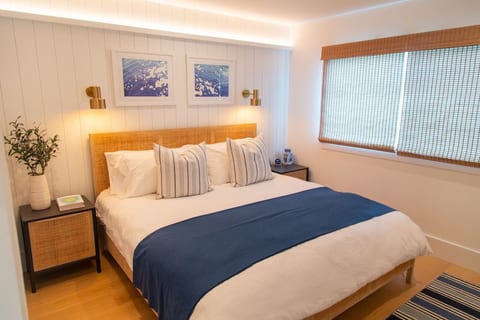 The Master — Harbor Lookout's flagship room. A premium king bed with crisp Brooklinen percale sheets is paired with LED ambient lighting, blackout shades, and rare central A/C for the kind of sleep you come to the beach for. 55" TV for winding down