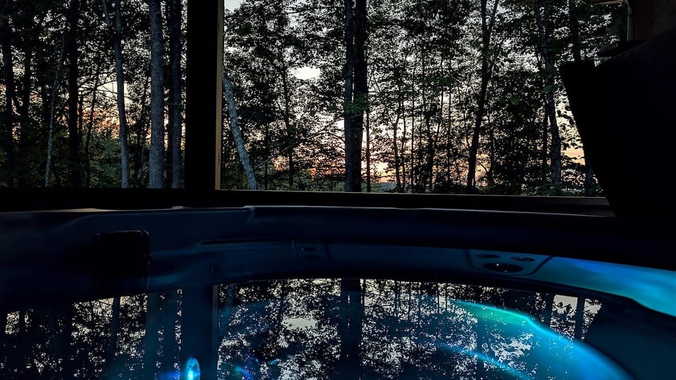 Soak in the private hot tub as the sun sets and twilight settles over the forest.