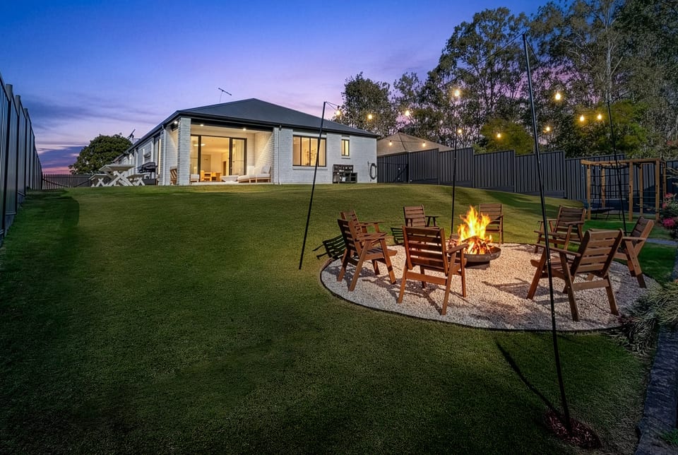 Outdoor Area : A spacious backyard made for memorable evenings, with a fire pit, outdoor seating and plenty of room to enjoy.