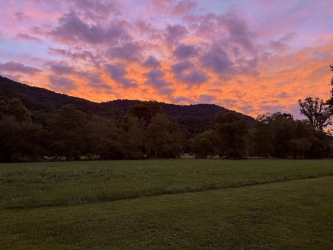 Sun setting behind the mountain overlooking the river. This is the view from the back porch.