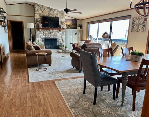 Family room and dining area with a mountain view, ceiling fan for added comfort