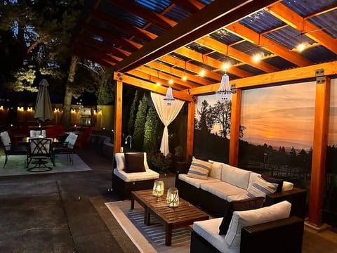 Not a normal backyard • Custom Designed Trellis - Real wood (not a kit) • Comfy Couch • Landscape lighting year-round • BBQ • Dining Area • Fire-pit • Outdoor Shower • Perfect for evening gathering and storytelling.