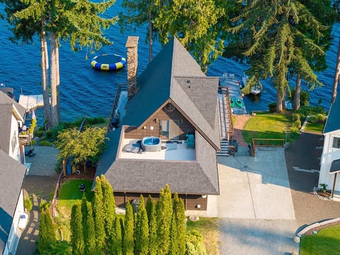 Aerial view of the home, private dock, and peaceful waterfront setting

Floating water bouncer stays in the water May - October!