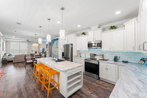 Spacious kitchen, fully stocked for culinary adventures! Enjoy multiple coffee options (drip, Keurig, coffee pot) & island seating for four. Perfect for cooking, entertaining & morning brews.