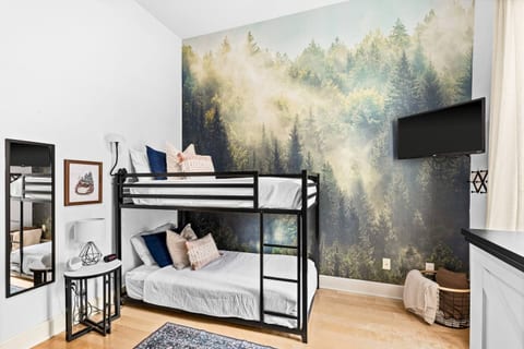 Kids and adults alike will love this cozy bunk room featuring a Northwoods inspired mural and plenty of space to rest and recharge