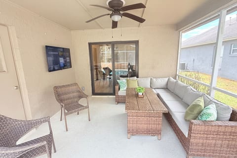 Covered patio with outdoor TV and seating