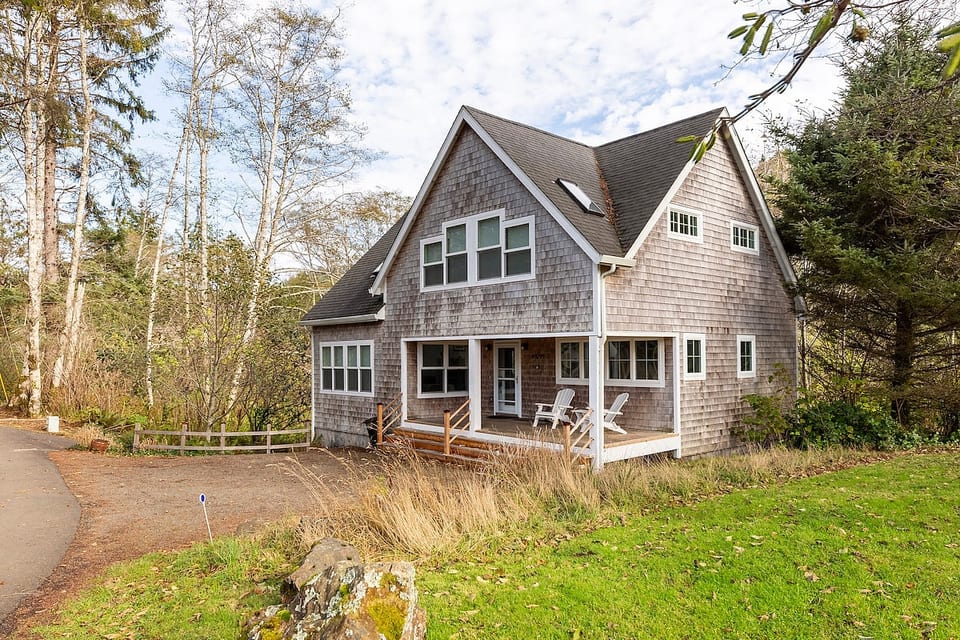 Classic beach house nestled on 1.5 acres of wooded land.