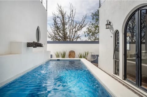 Heated pool with sitting ledge is approximately 5 feet deep