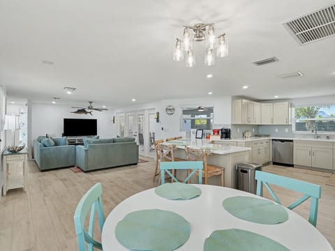 Gather with family and friends in the bright, open-concept living, dining, and kitchen area, designed for relaxing and spending time together.