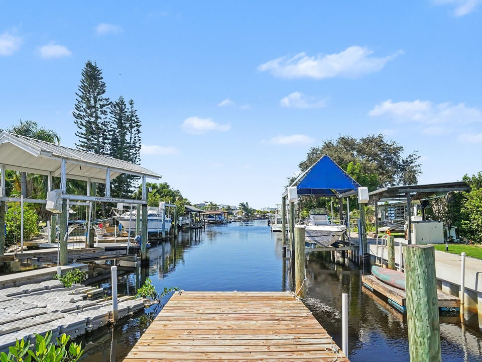 Step onto your private dock and enjoy peaceful canal views at White Heron Landing, your waterfront retreat in Ruskin, Florida.