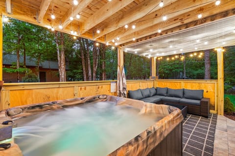 Unwind in our 6-person hot tub after a full day out. The covered deck lets you enjoy it rain or shine with a 5 person sectional—perfect for conversation or card games. The walls allow for privacy while still allowing guests to enjoy the outdoors