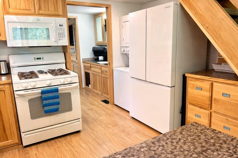 Full kitchen with gas range and French door refrigerator