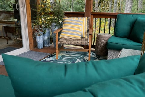 Covered patio with deep Sunbrella lounge seating, usable even when it drizzles