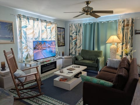 Cozy tropical lounge w/ smart TV, fireplace, and comfy seating