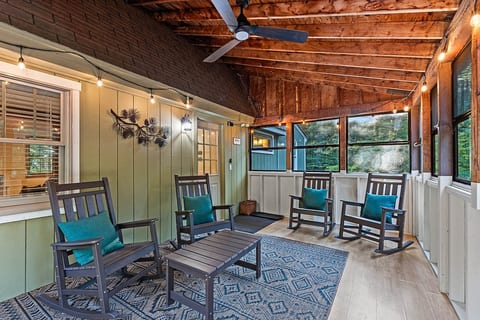 A cozy screened-in space for morning coffee, evening drinks, or simply listening to the river.