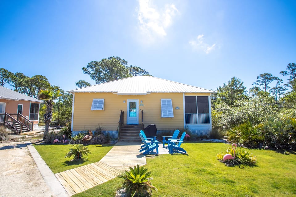 Front of Cottage, parking to the Left of wood sidewalk