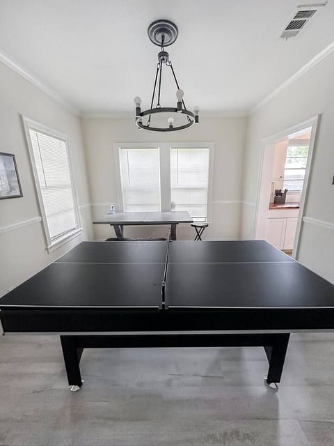 Challenge your friends to a fun ping pong match, then gather around the stylish dining table for a meal or game night. A perfect space for fun and connection!