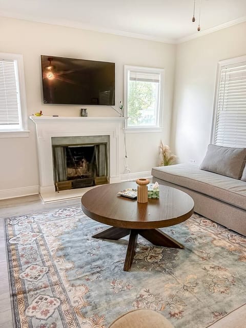 Unwind in this airy, sunlit living room with comfy seating, a smart TV over the fireplace, and stylish decor. Perfect for relaxing after a day out!