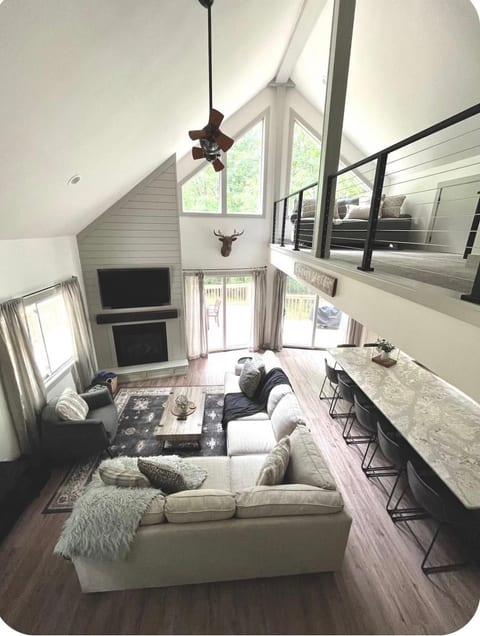 Stairwell views. Upstairs loft with sofa bed with mattress topper, smart TV, and Nintendo Wii.