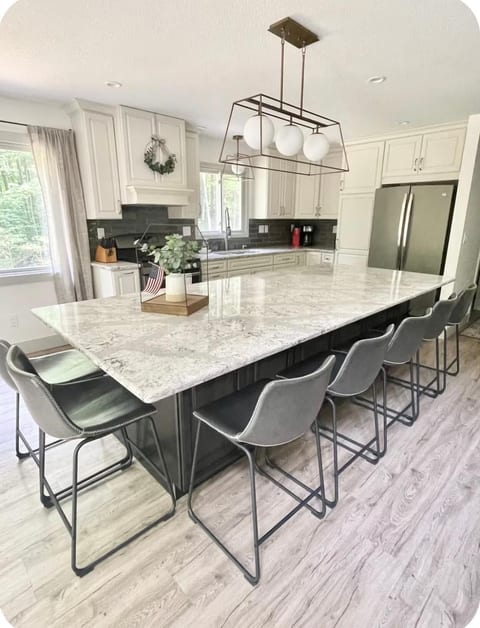 Fully kitchen with many amenities and large granite island for gathering of groups or office space.