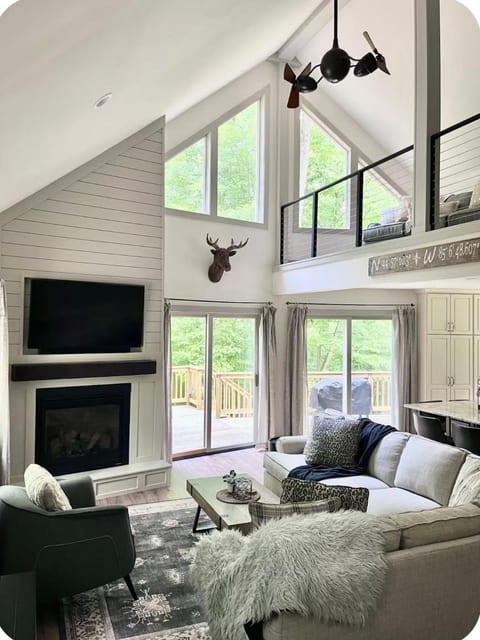 Main floor with gas fireplace and smart TV with scenic views from several window views.