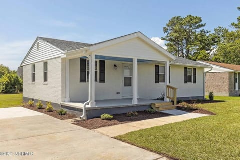 Front yard, parking spot, and front of house.