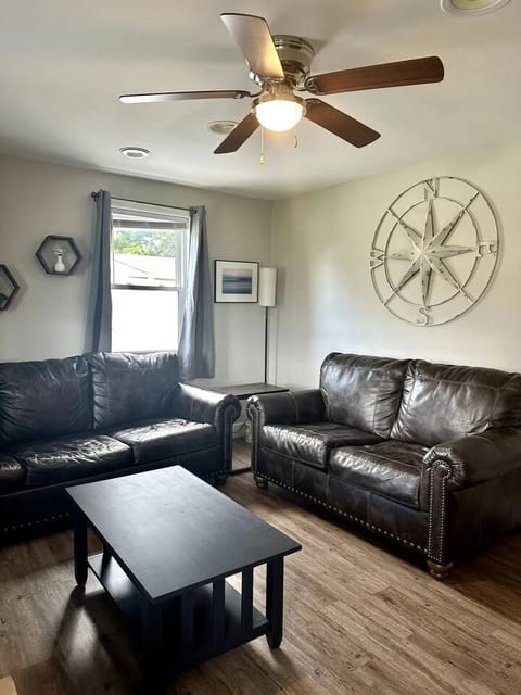 Comfortable living room with two sofas, tv, and coffee table.