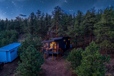 Watch the cabin glow like a lantern in the pines as the stars come out above the ridge.